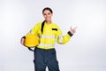 Photo of positive happy young fire lady workwear holding yellow helmet pointing finger empty space isolated white color Royalty Free Stock Photo