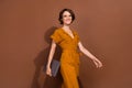 Photo of positive happy young woman hold laptop walk good mood business lady isolated on brown color background