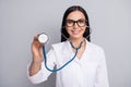 Photo of positive lady doctor wear white coat eyeglasses listening heart phonendoscope isolated grey color background