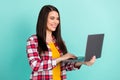 Photo of positive lovely young woman hold computer blog write isolated on pastel teal color background