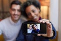 Mixed race couple making selfie with phone in cafe Royalty Free Stock Photo