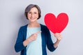 Photo of positive pretty old happy lady point finger large red paper heart romance isolated on grey color background