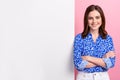 Photo of positive satisfied glad cheerful businesswoman wear blue shirt crossed arms near paper advert proposition