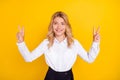 Photo of positive schoolgirl show two v-signs shine smile wear white shirt isolated yellow color background