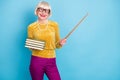 Photo of positive short hairdo aged lady hold book stick wear eyewear blouse pants isolated on blue color background