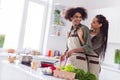 Photo of positive sweet boyfriend girlfriend wear aprons smiling cook breakfast hugging indoors room home Royalty Free Stock Photo