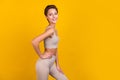 Photo of positive tender lady hand waist posing beaming smile wear grey top yellow color background