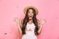 Photo of positive woman 20s wearing straw hat laughing while sta