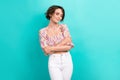 Photo of positive woman with short hairstyle wear colorful top embrace herself enjoy soft clothes isolated on turquoise Royalty Free Stock Photo