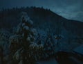 Night in the mountains. Lonely house on the slope. Winter evening.