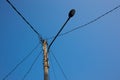 Photo of power pole under clear blue sky in the morning. Power pole photo with dangling wire. Power pole cable Royalty Free Stock Photo