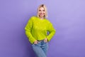 Photo of pretty adorable lady wear green pullover smiling hands arms pockets isolated purple color background