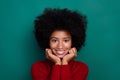 Photo of pretty adorable little school girl dressed red sweater smiling arms cheeks isolated green color background Royalty Free Stock Photo