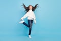 Photo of pretty adorable student girl wear white sweater smiling walking wind blowing isolated blue color background