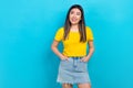 Photo pretty asian girl model wear t-shirt denim short skirt look side empty space advertise outfit  blue color Royalty Free Stock Photo