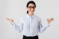 Photo of pretty businesswoman wearing eyeglasses laughing while standing in the office, isolated over white background Royalty Free Stock Photo