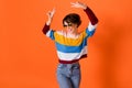 Photo of pretty carefree girl look empty space two hands fingers show v-sign isolated on orange color background Royalty Free Stock Photo