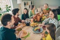 Photo of pretty charming family celebrating thanks giving day sitting table talking smiling indoors room home Royalty Free Stock Photo