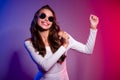 Photo of pretty clubber lady dance techno rave wear sunglass shirt isolated neon gradient color background