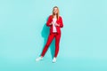 Photo of pretty confident orange hair woman dressed red jacket smiling isolated cyan color background Royalty Free Stock Photo