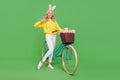 Photo of pretty confident woman wear yellow sweater headband riding bike thumb up isolated green color background Royalty Free Stock Photo