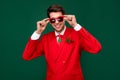 Photo of pretty cool santa claus guy dressed red jacket arms glasses smiling isolated green color background Royalty Free Stock Photo