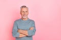 Photo of pretty cute man pensioner dressed grey shirt looking empty space arms crossed isolated pink color background Royalty Free Stock Photo