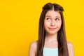 Photo of pretty cute small dreamy girl look empty space imagine idea isolated on shine yellow color background Royalty Free Stock Photo