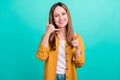 Photo of pretty cute young woman dressed yellow shirt smiling pointing finger you asking call her isolated teal color Royalty Free Stock Photo