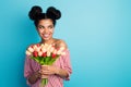 Photo of pretty dark skin lady hold big fresh tulips bunch adorable look side empty space 8 march wear striped red white