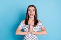 Photo of pretty excited girl open mouth hold hands plead wear dotted blouse isolated blue color background