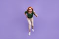 Photo of pretty excited young woman dressed off-shoulders blouse running fast jumping high isolated violet color Royalty Free Stock Photo