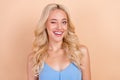 Photo of pretty flirty young woman dressed blue tank-top winking smiling beige color background