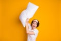 Photo of pretty funky lady hold hands big pillow fight morning quarantine stay home slumber party wear night mask white