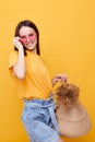 photo pretty girl Beach bag fashion in yellow t-shirt denim shorts yellow background Royalty Free Stock Photo