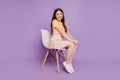 Photo of pretty gorgeous lovely girl sit chair hands knees on violet background Royalty Free Stock Photo