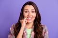 Photo of pretty guilty young woman bite teeth nails wear plaid shirt isolated on purple color background