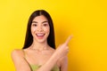 Photo of pretty imressed young lady wear green outfit pointing empty space  yellow color background Royalty Free Stock Photo