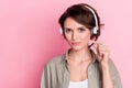 Photo of pretty lady operator hand touch adjust mic look camera isolated on pink color background