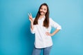 Photo of pretty lady playing long hairstyle curl making mustache showing v-sign wear shirt jeans isolated blue color