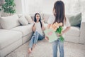 Photo of pretty little girl young charming brunette mommy waiting 8 march present girl hiding postcard tulips flowers