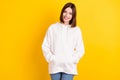 Photo of pretty lovely cheerful lady hands pockets posing wear white sweatshirt isolated yellow color background