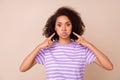 Photo of pretty shiny girl dressed purple t-shirt pointing fingers bloated cheeks isolated beige color background