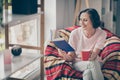 Photo of pretty shiny senior lady wear casual outfit smiling sitting chair plaid blanket reading book drinking beverage Royalty Free Stock Photo