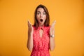 Photo of pretty shocked emotionally woman in red dress looking a