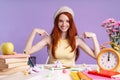 Photo of pretty student girl pointing finger at herself while sitting at desk Royalty Free Stock Photo