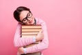 Photo of pretty student lady hugging hands literature pile diligent pupil fond of reading eyes closed dreamer book worm Royalty Free Stock Photo