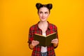 Photo of pretty student lady two buns read interesting story favorite novel look up empty space dreamer romantic mood Royalty Free Stock Photo