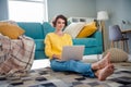 Photo of pretty successful recruiter girl sitting fluffy carpet use wireless netbook coworking inside room flat Royalty Free Stock Photo