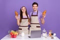 Photo of pretty sweet boyfriend girlfriend dressed chef outfits cooked tasty pastry gadget isolated purple color